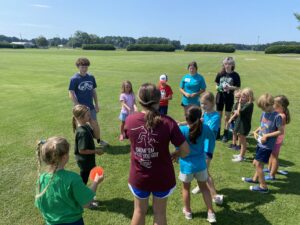 teen leaders leading campers in a game 